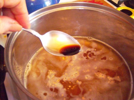 adding soy sauce to pot