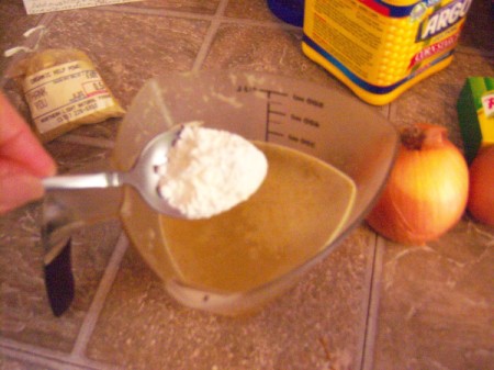adding corn starch to cup of broth