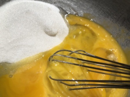 adding sugar to egg