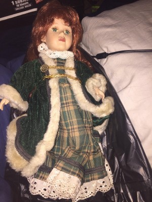 Identifying a Porcelain Doll - doll wearing a plaid dress and green long fur trimmed coat