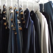 Clothes hanging from chains in the closet.