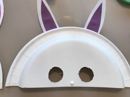 Paper Plate Bunny Mask - purple ears in place and drop of glue for nose