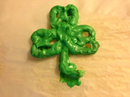 Shamrock Pretzel on paper with drops of melted candy to glue shamrock