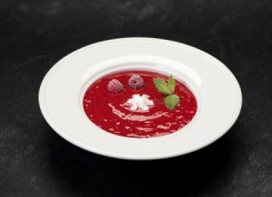 Raspberry Soup in a white bowl on a black table