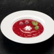 Raspberry Soup in a white bowl on a black table