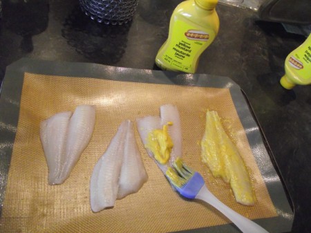spreading mustard on Fish
