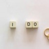Three small blocks spelling "I Do" next to two rings.