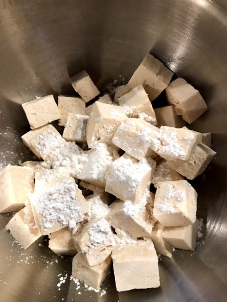 mixing tofu with olive oil and corn starch