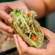 A person holding a taco, ready to eat.