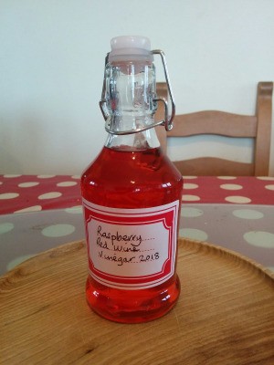 A bottle of homemade raspberry red wine vinegar.