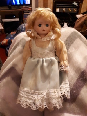 Identifying a Porcelain Doll - blond doll with white pinafore over pinkish blouse