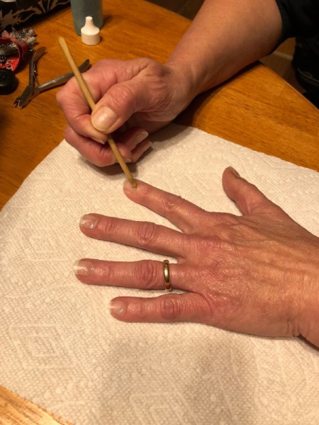 DIY Manicure - using an orange stick to push back cuticle