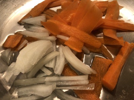 onions and carrots in pan