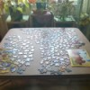 A jigsaw puzzle being worked on a card table.