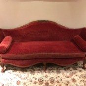 Value of a Vintage Davenport Couch - red vintage couch with scrolled back and front and bolster pillows as arms