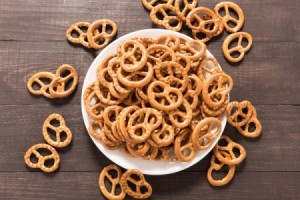 A batch of small pretzels in a white bowl.