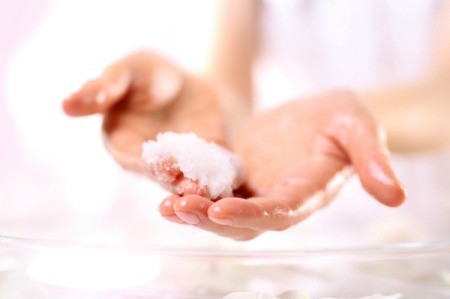 Woman with sugar held in her hand to use as as scrub