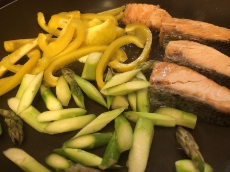 cooking pepper slices and onions