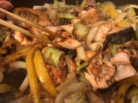 breaking up salmon in pan