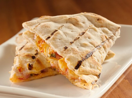 Chicken Quesadillas on a white plate and wooden table