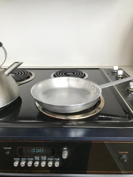 An omelet pan on a stove.