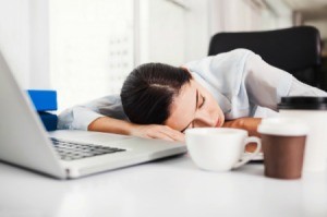 Woman sleeping at her work desk.