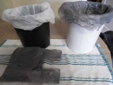 Plastic shopping bags used as wastebasket liners.