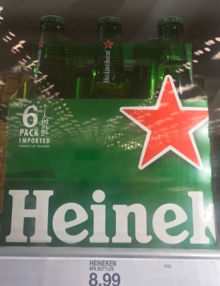 A six pack of Heineken beer in bottles.