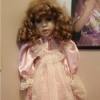 Identifying a Porcelain Doll - doll with reddish ringlets and wearing a pink dress