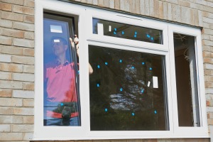 Man installing new windows with labels on them