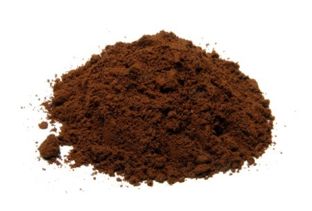Pile of coffee grounds on a white background