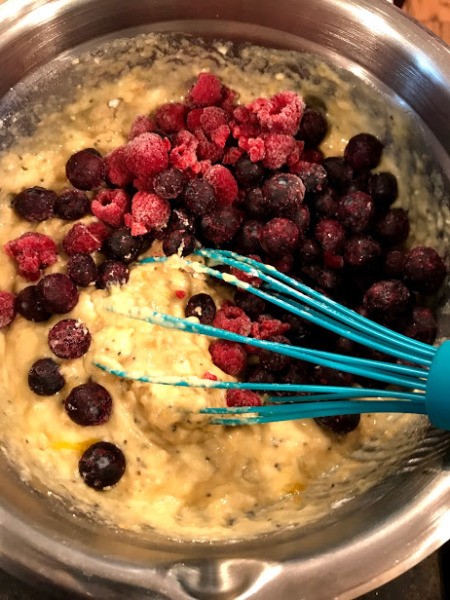 adding berries to batter