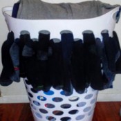 Air Dry Socks Using Laundry Basket Holes - socks hanging out of the holes