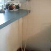 A very long telephone cord, attached to a wall phone.