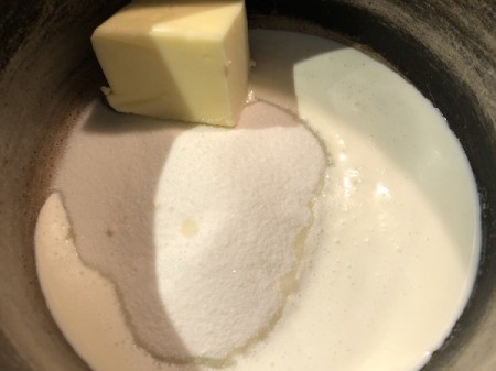 heavy cream, butter and sugar heating in pan