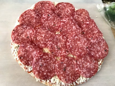 A cheese pizza topped with salame.