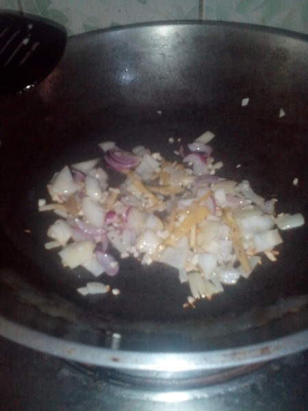 chopped onion and ginger in pan