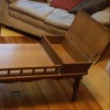 Value of a Mersman Coffee Table - medium wood finish table with covered end compartments and railing between