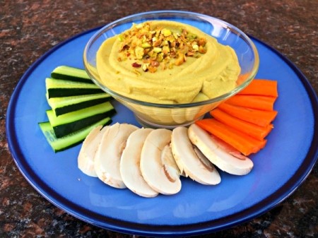 Pistachio Hummus on plate with cut vegetables