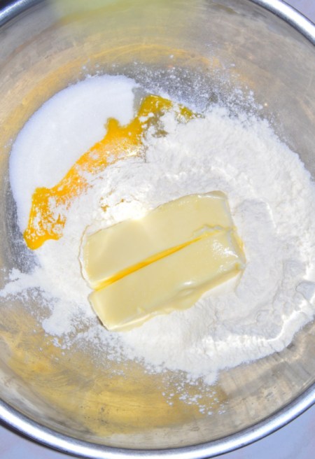 butter, flour and egg yolk in bowl