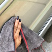 Tips for Waxing Cars - woman's hand holding a microfiber cloth