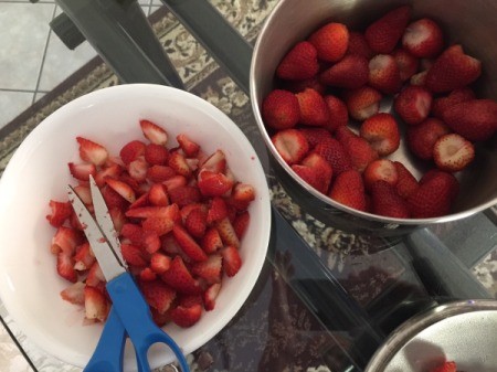 cutting strawberries with shears