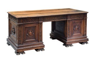 Carved antique wooden desk on a white background
