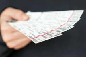 Man holding tickets to sports game