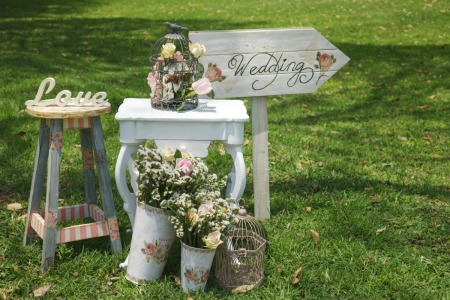 Vintage themed wedding and reception decorations on grass