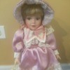 Value of Heritage Porcelain Dolls - doll wearing a pink satin and lace dress