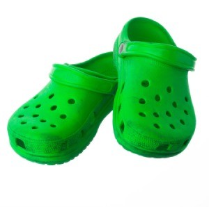 Green crocs on a white background