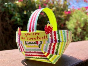 Craft Paper Basket - basket sitting outside on deck railing