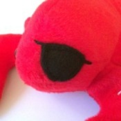 A stuffed red lobster with a black eye patch covering where an eye is missing.