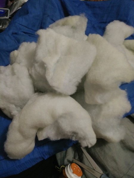 Stuffing from a pillow that is clumped.